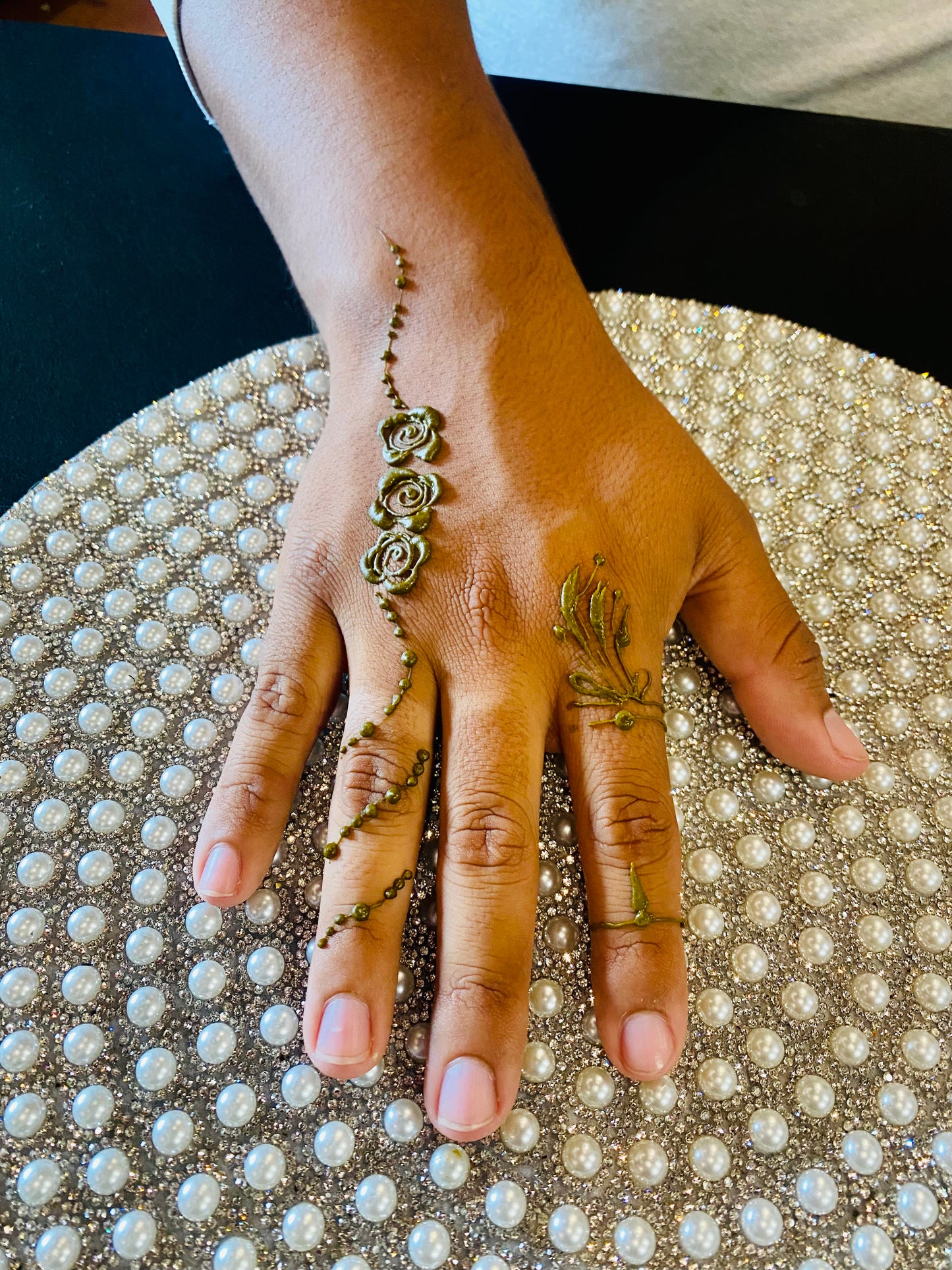 A hand showing the quality of the henna paste