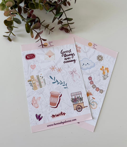 Two sticker sheets with illustrations and text on a light background with greenery.