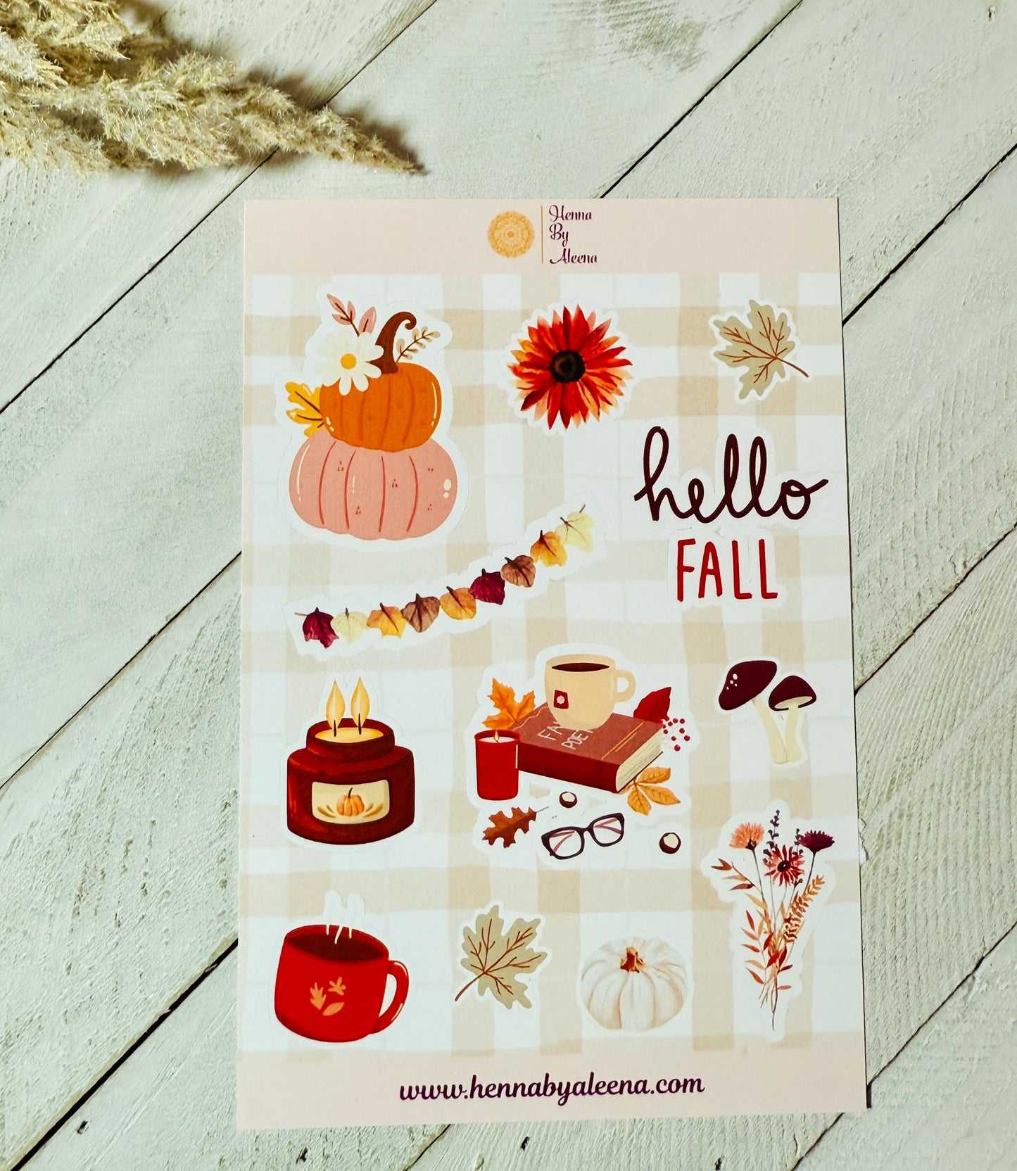 Sheet of fall-themed stickers with pumpkins, leaves, and 'hello fall' text on a checkered background.