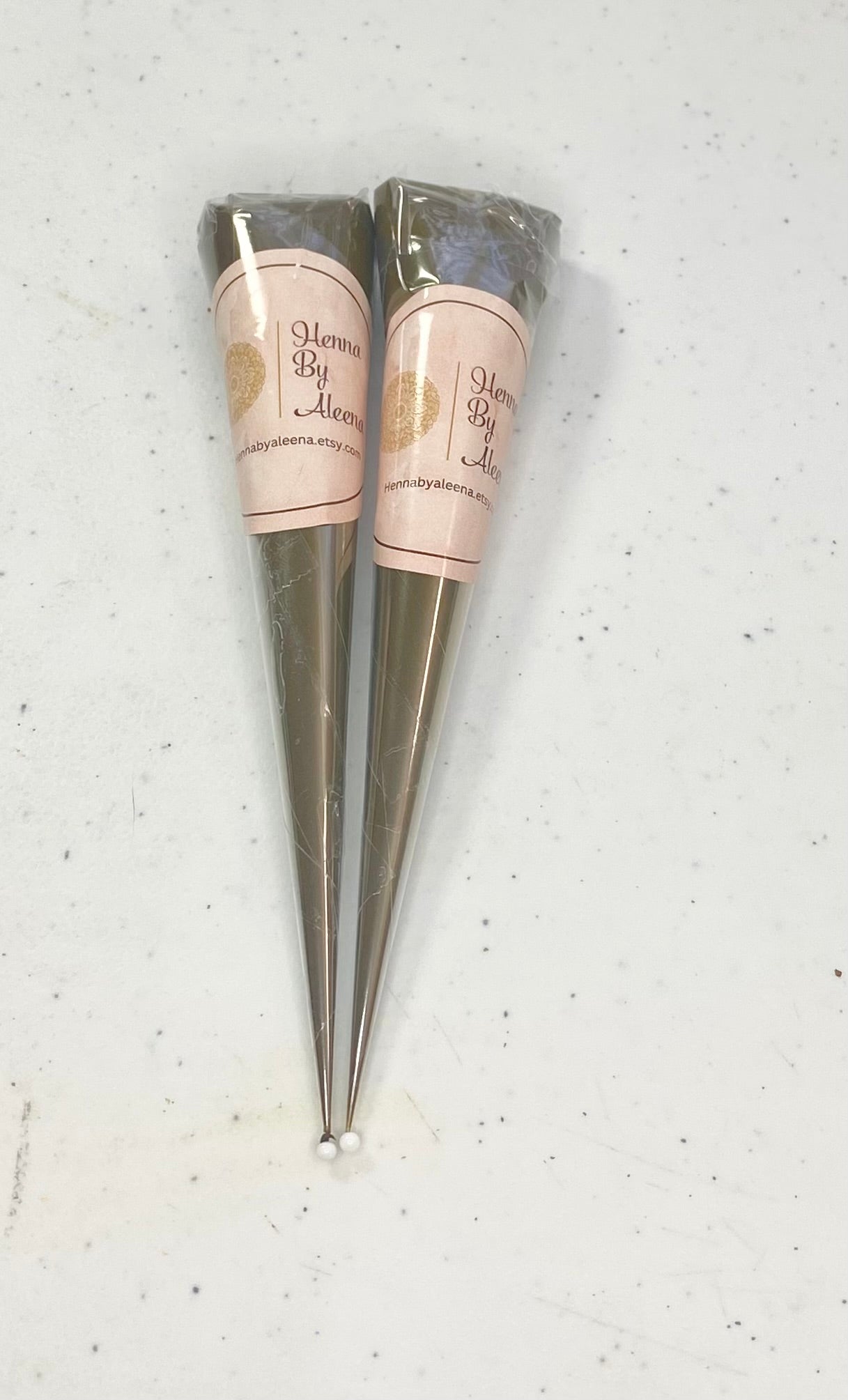 Two henna cones against  a white background 