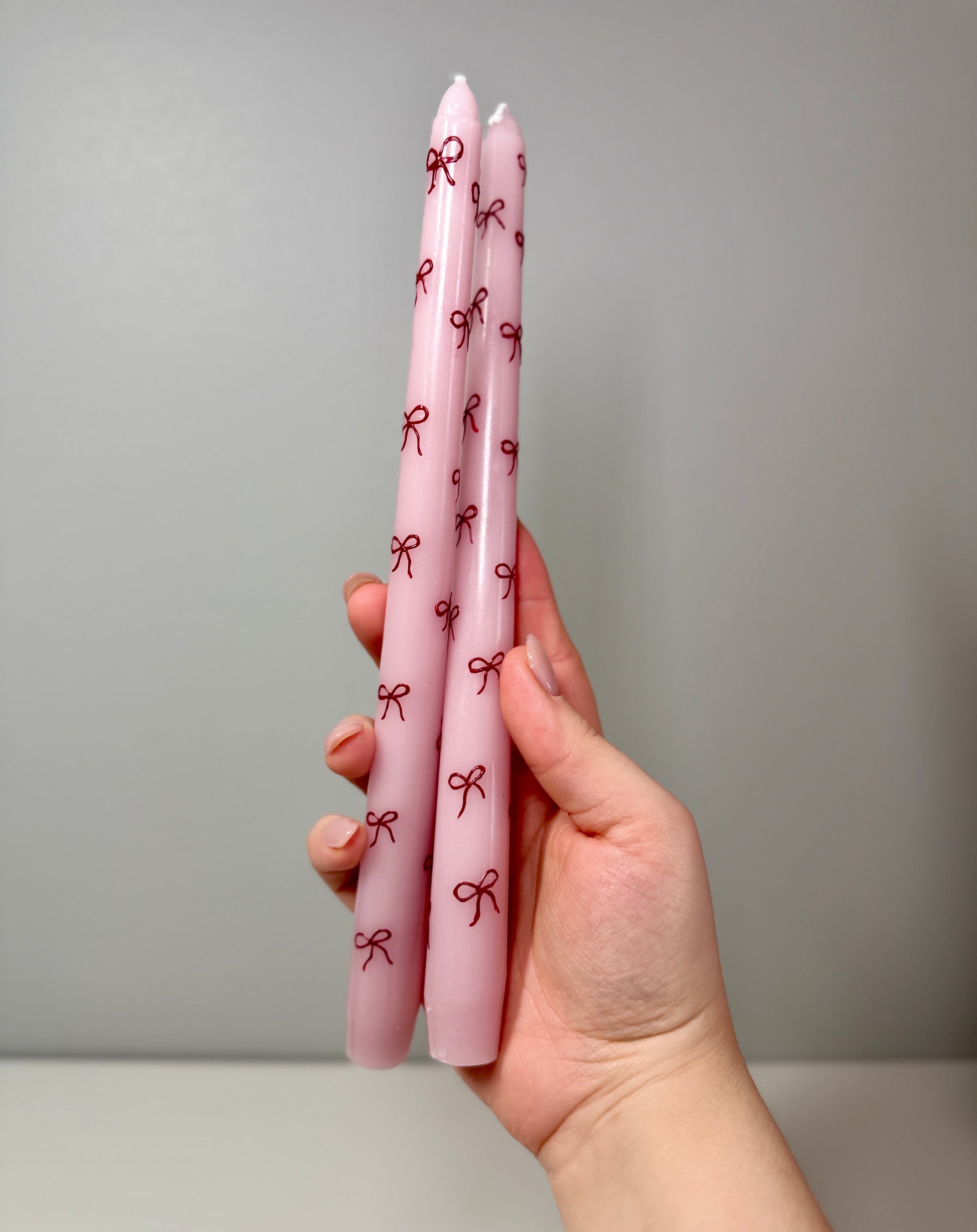 Pink Tapered Candles With Red Bows