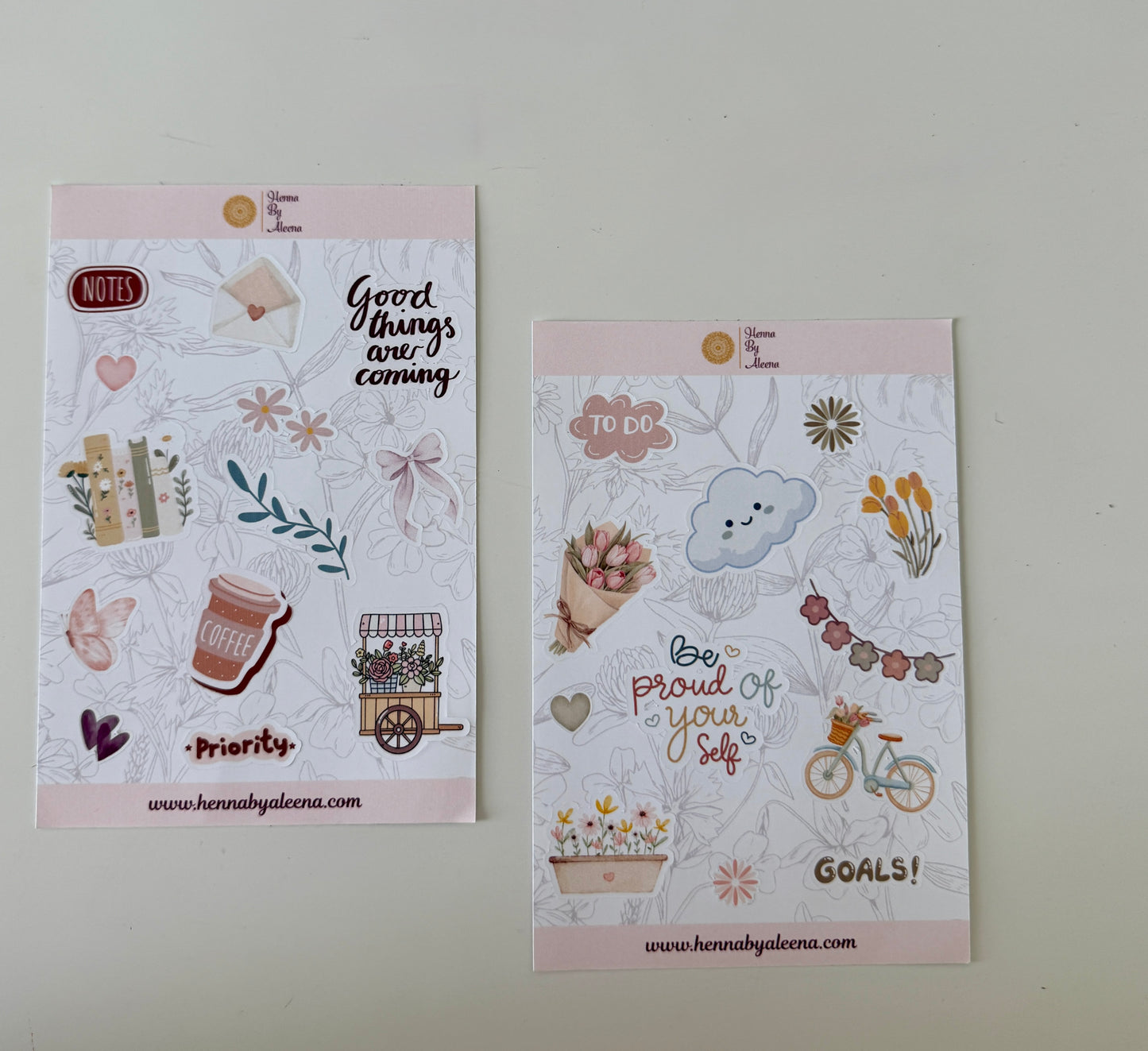 Two decorative paper sheets with illustrations and text on a light gray background