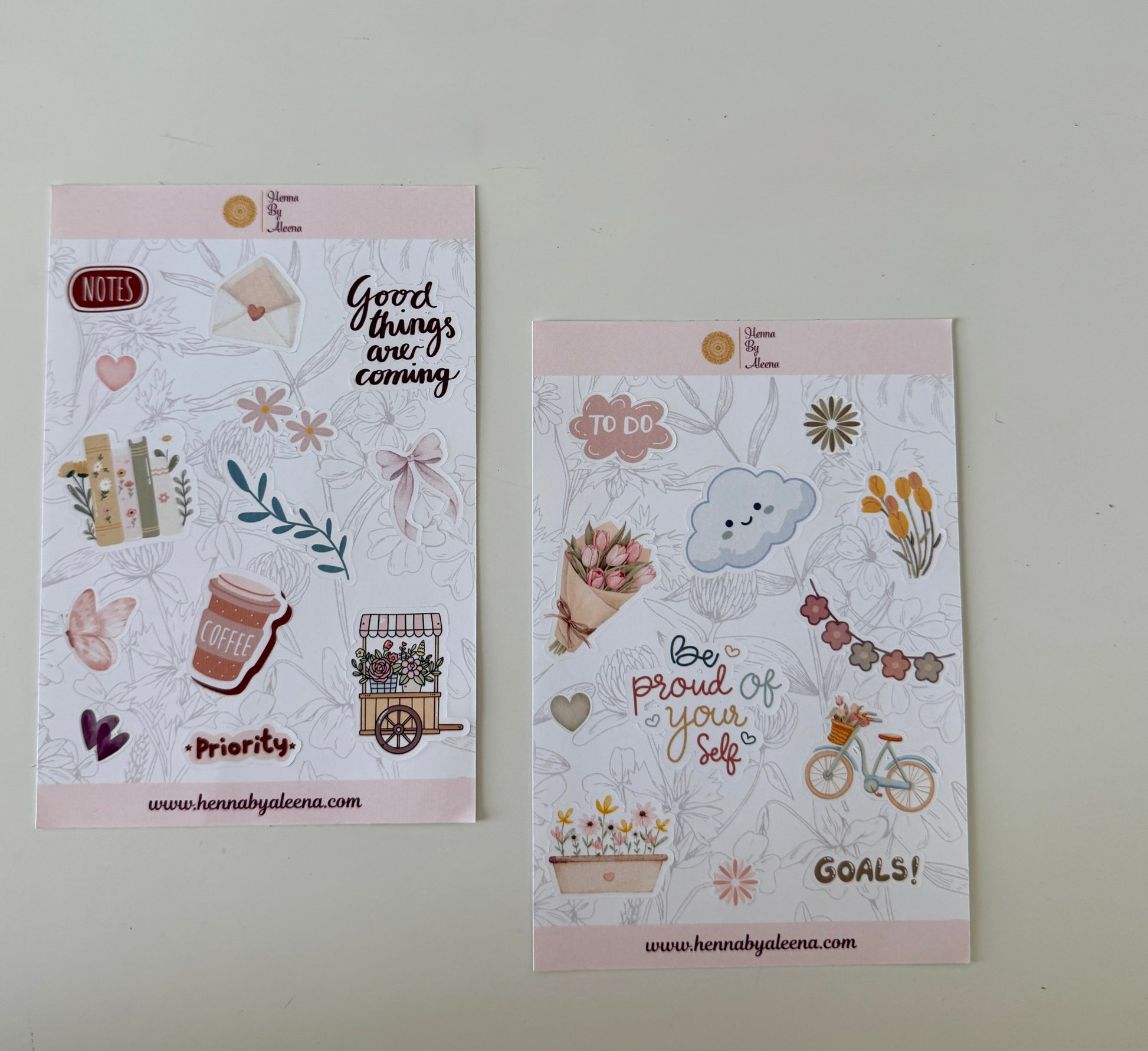 Two decorative paper sheets with illustrations and text on a light gray background