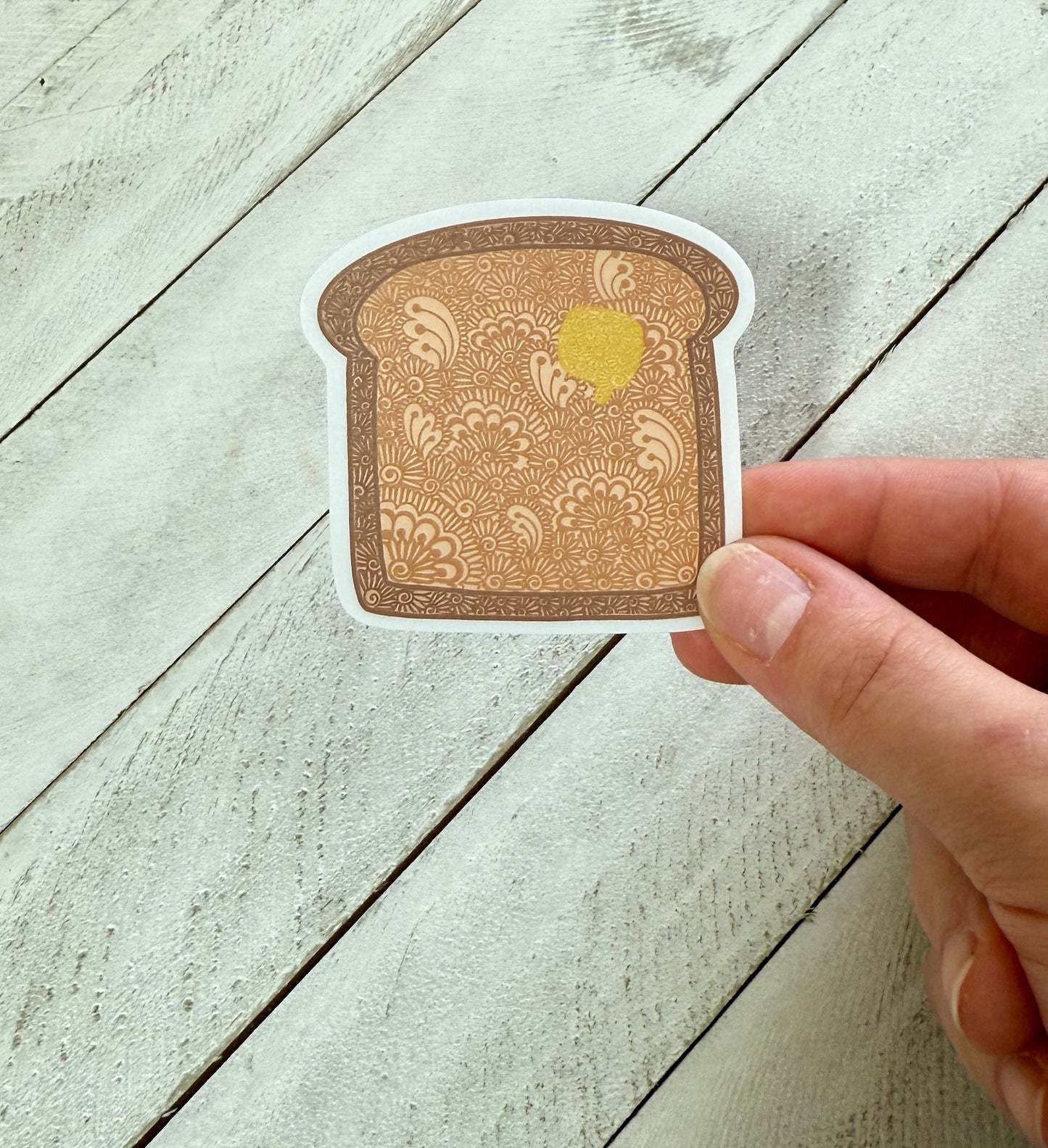 Decorative toast slice sticker on a wooden surface