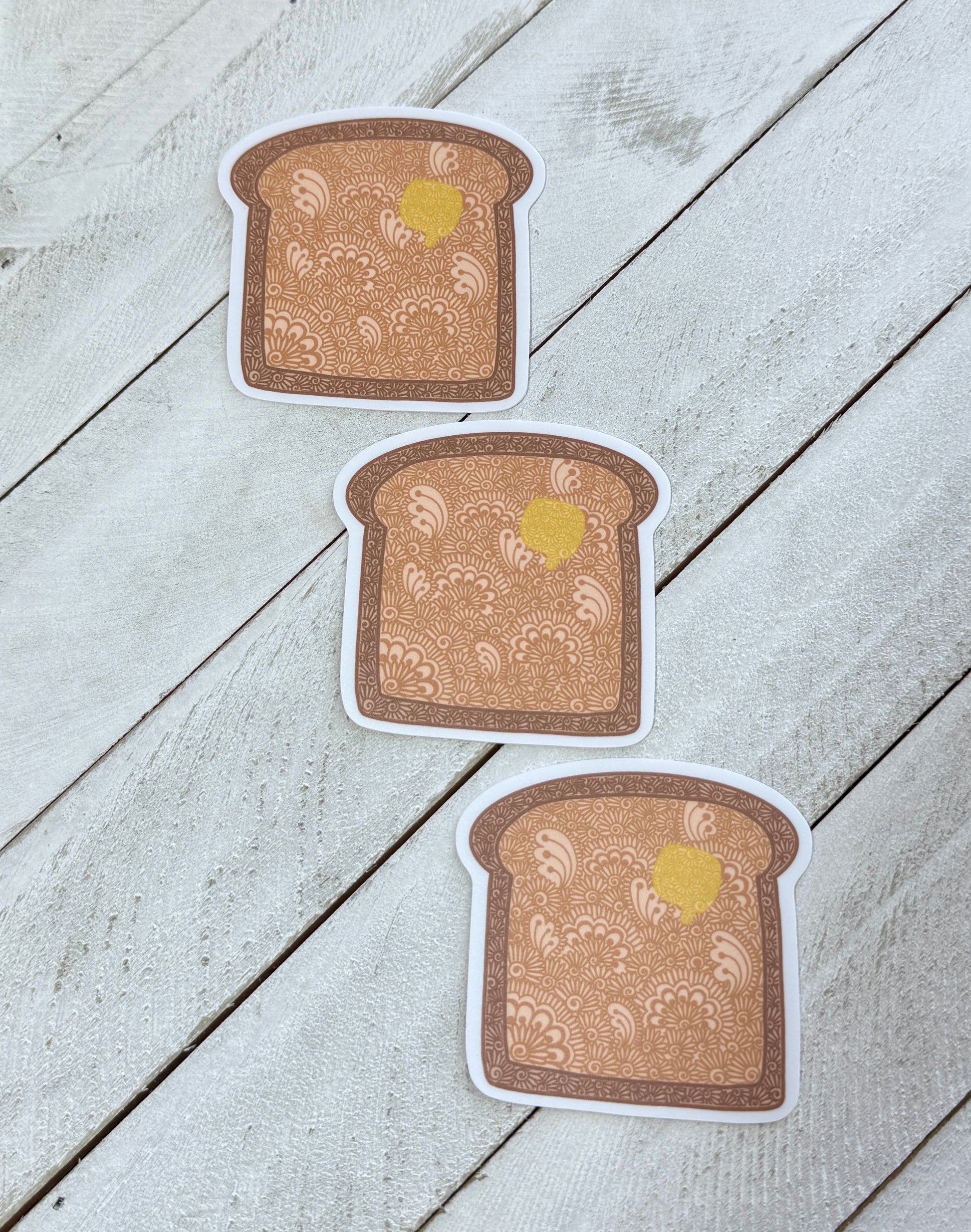 Three slices of toast with a yellow center on a light wooden surface