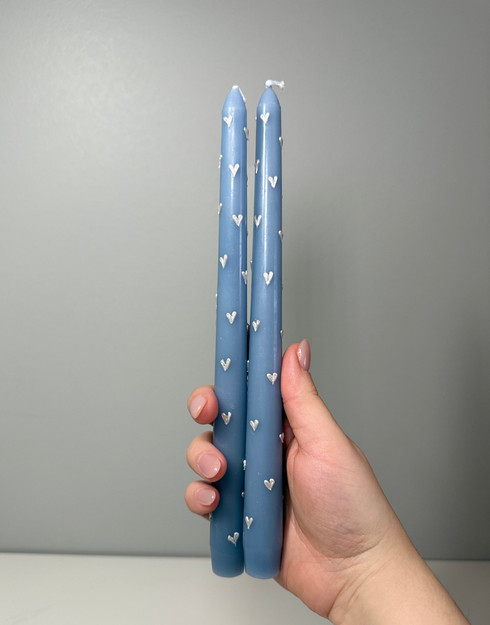 Blue taper candle with hearts 